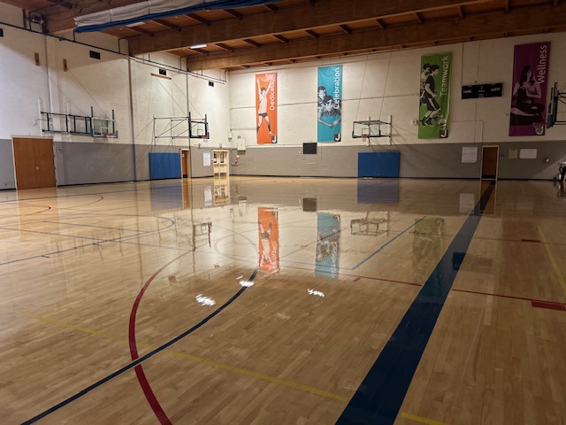 Gymnasium floor restored to a mirror shine by TBM floor care services in Portland